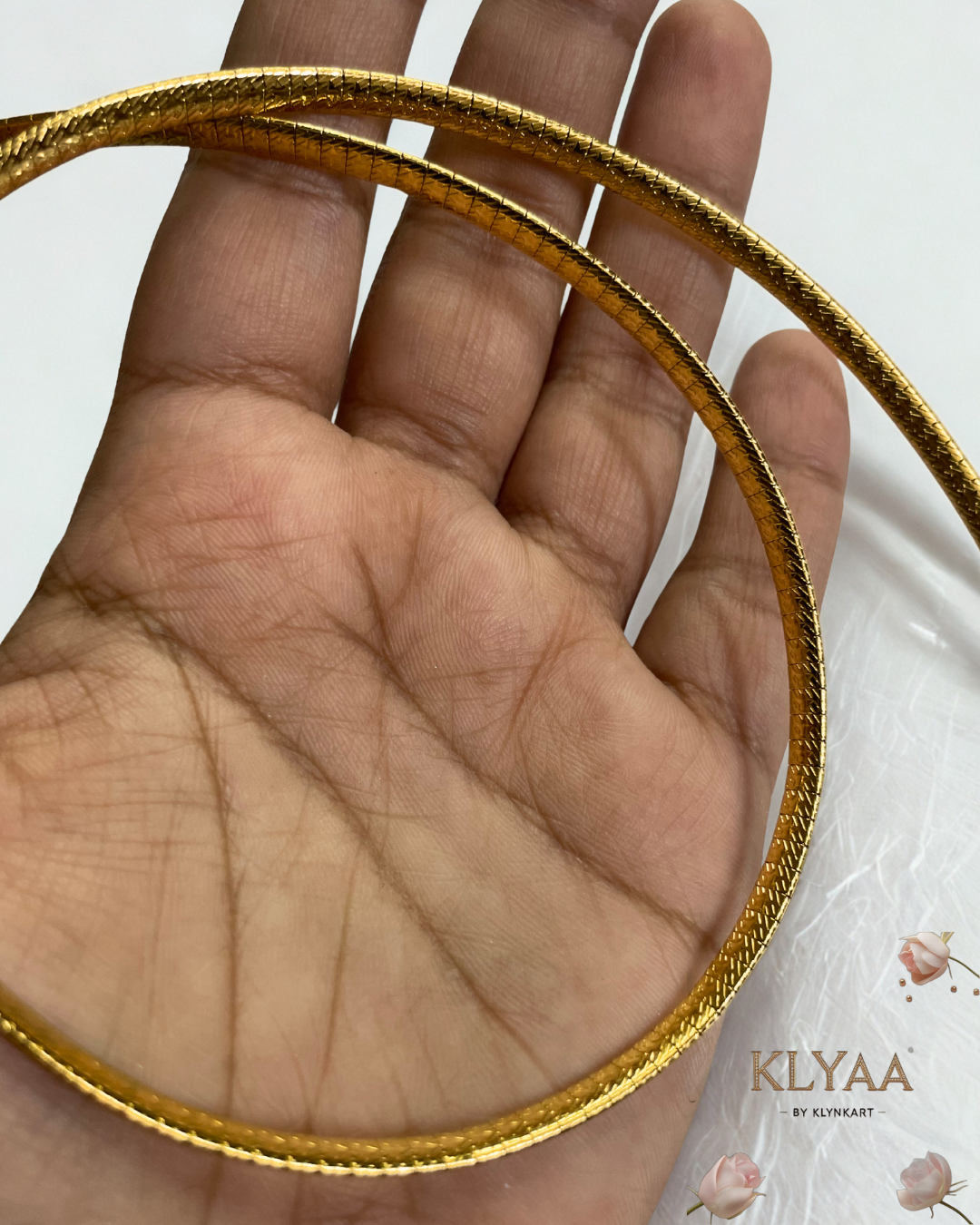 Sleek 18K Gold Plated anti-tarnish huslee neckpiece by KLYAA styled on soft beige fabric