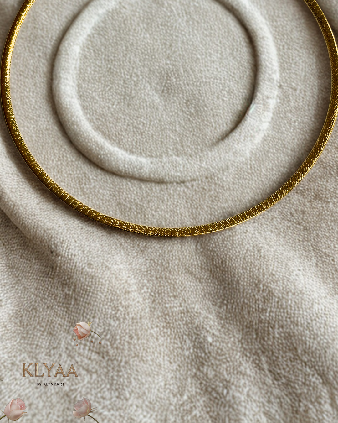 Sleek 18K Gold Plated anti-tarnish huslee neckpiece by KLYAA styled on soft beige fabric
