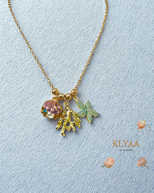Luxury gold chain with ocean-inspired charms, featuring a purple seashell, gold coral, and blue starfish by KLYAA