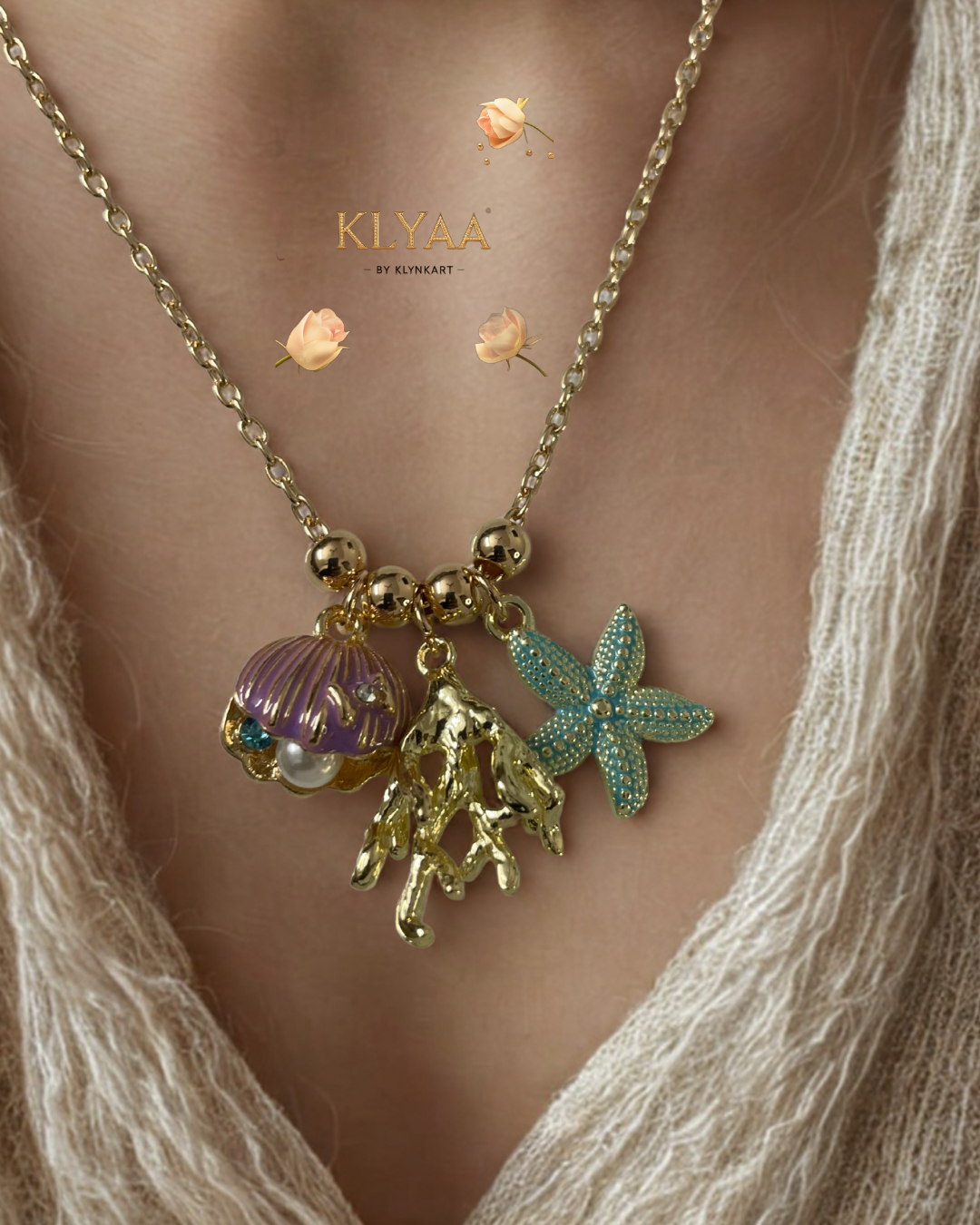 Luxury gold chain with ocean-inspired charms, featuring a purple seashell, gold coral, and blue starfish by KLYAA