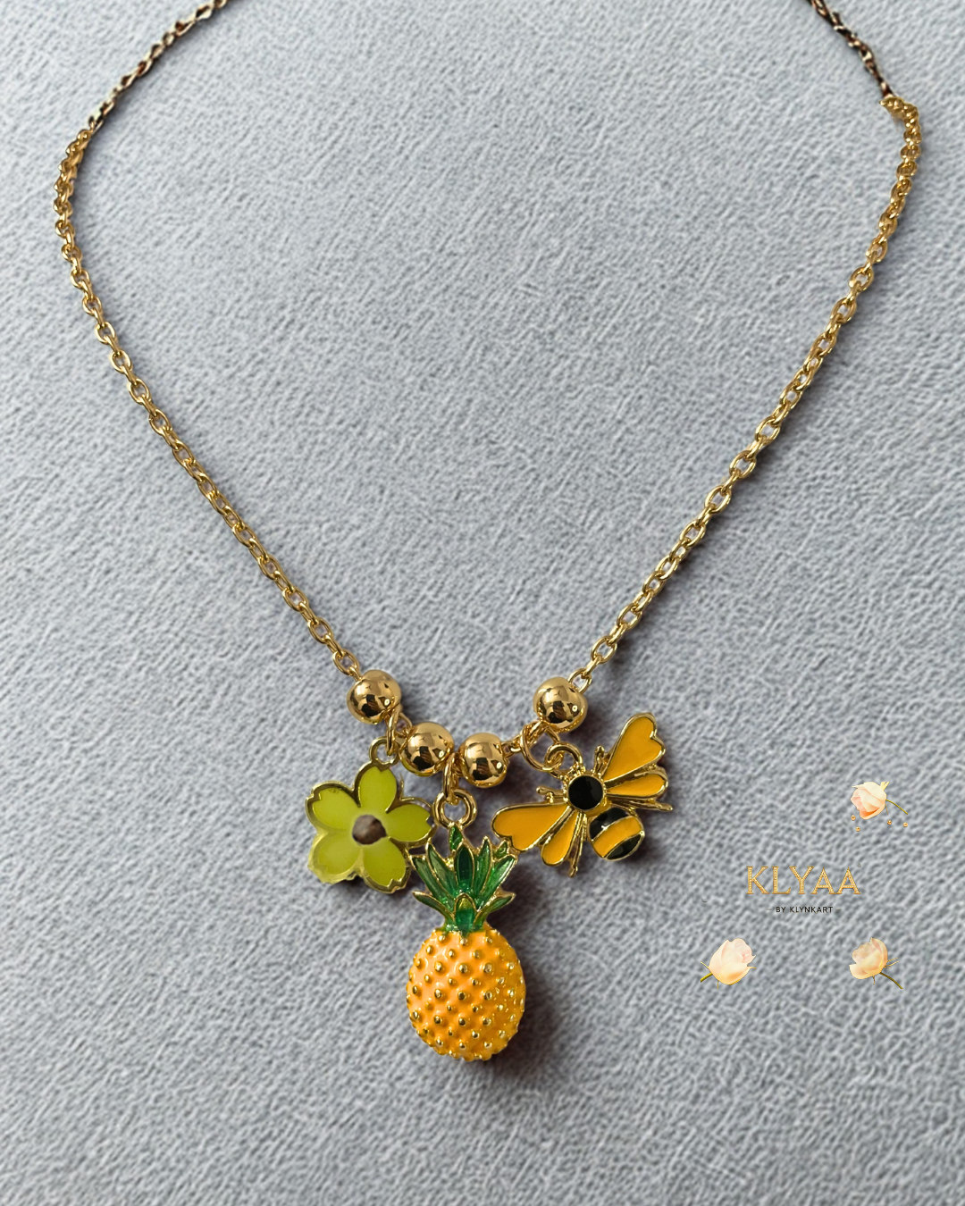KLYAA golden tropical necklace with charms - pineapple, bee, flower