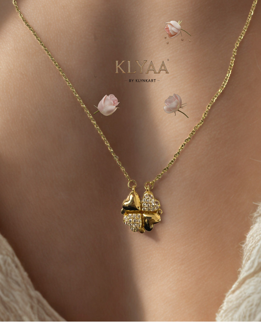 Close-up of KLYAA gold four-heart clover necklace worn on neckline