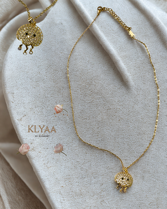 Gold-plated chain with a sea-creature-inspired pendant featuring crystal stones and three delicate danglers.