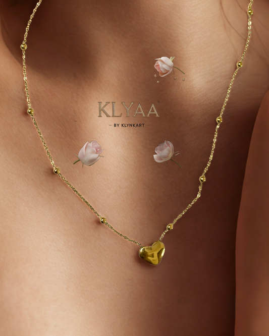 Model wearing KLYAA's Gilded Heart gold chain with molten heart pendant