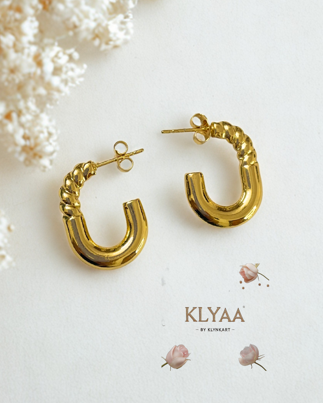 KLYAA TwistGold anti-tarnish gold hoop earrings styled on white fabric